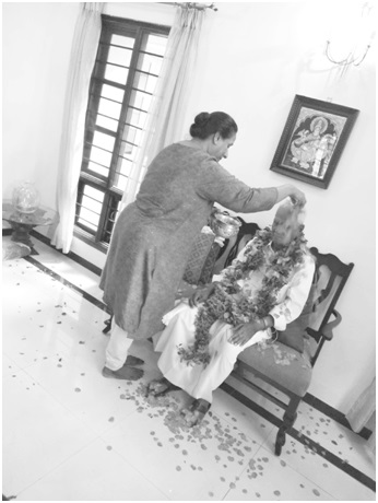 A devotee welcoming Thatha by showering of flowers